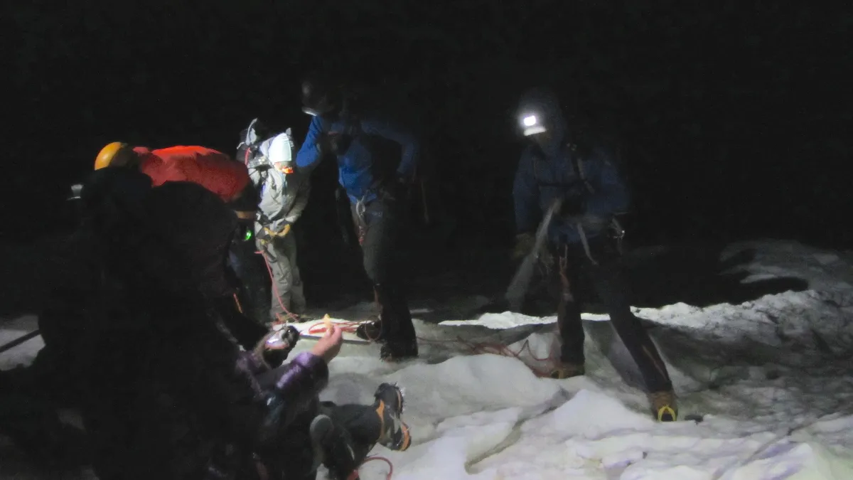 Night photo of the team preparing for summit